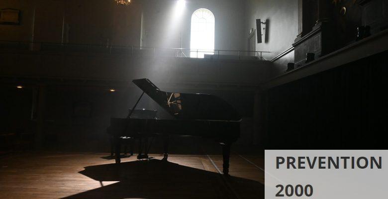 black grand piano on brown wooden floor