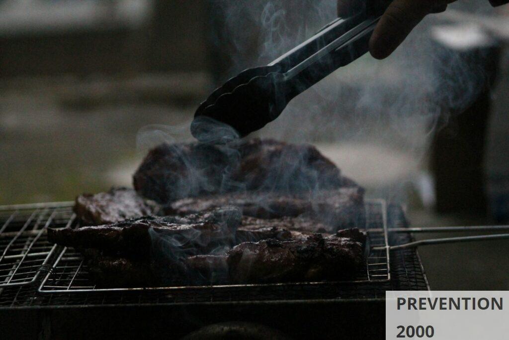 person grilling barbecue